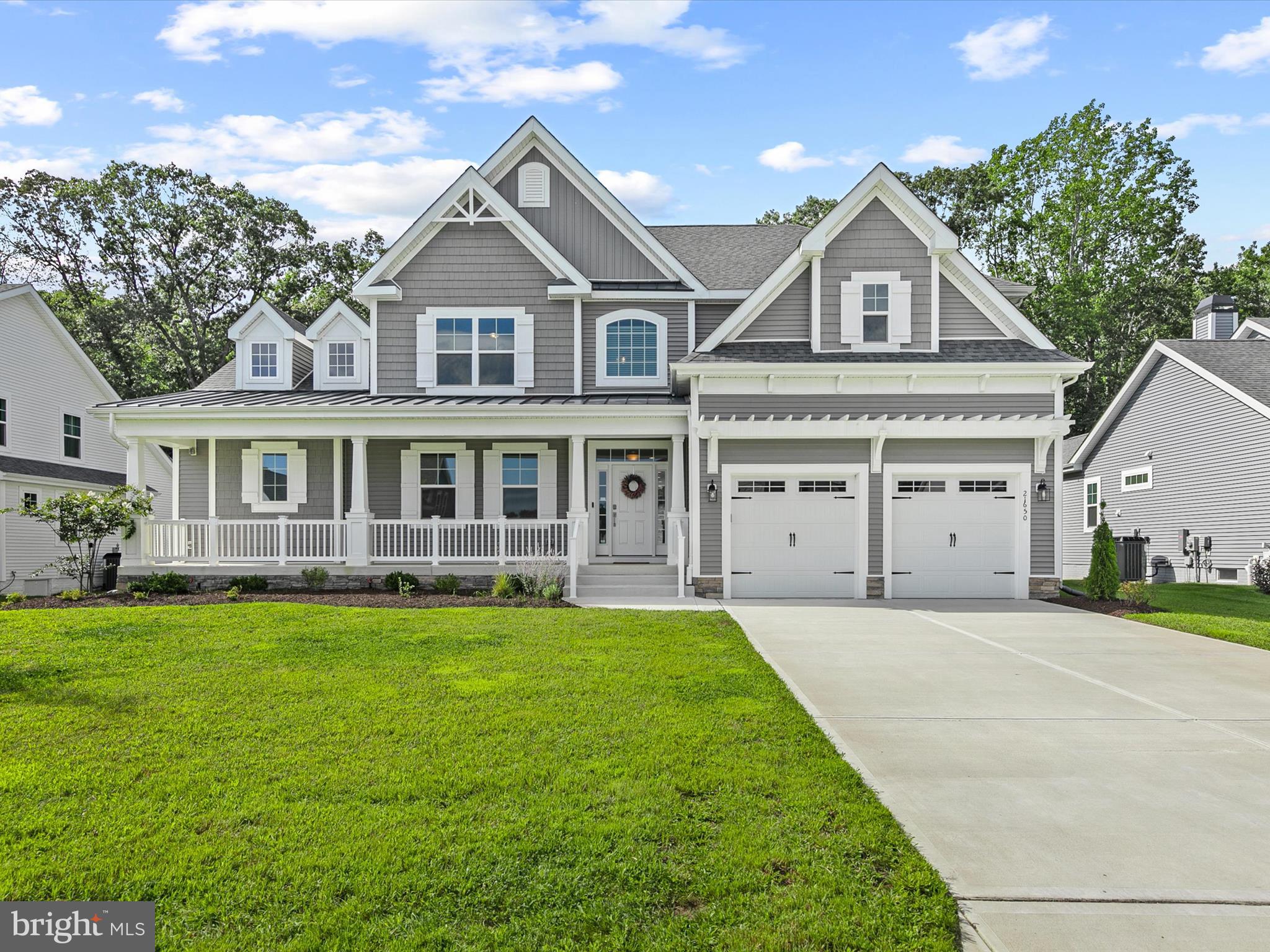 21650 Eastbridge Loop Lewes, DE 19958 - Photo 2 of 106 a front view of a house with a yard and trees