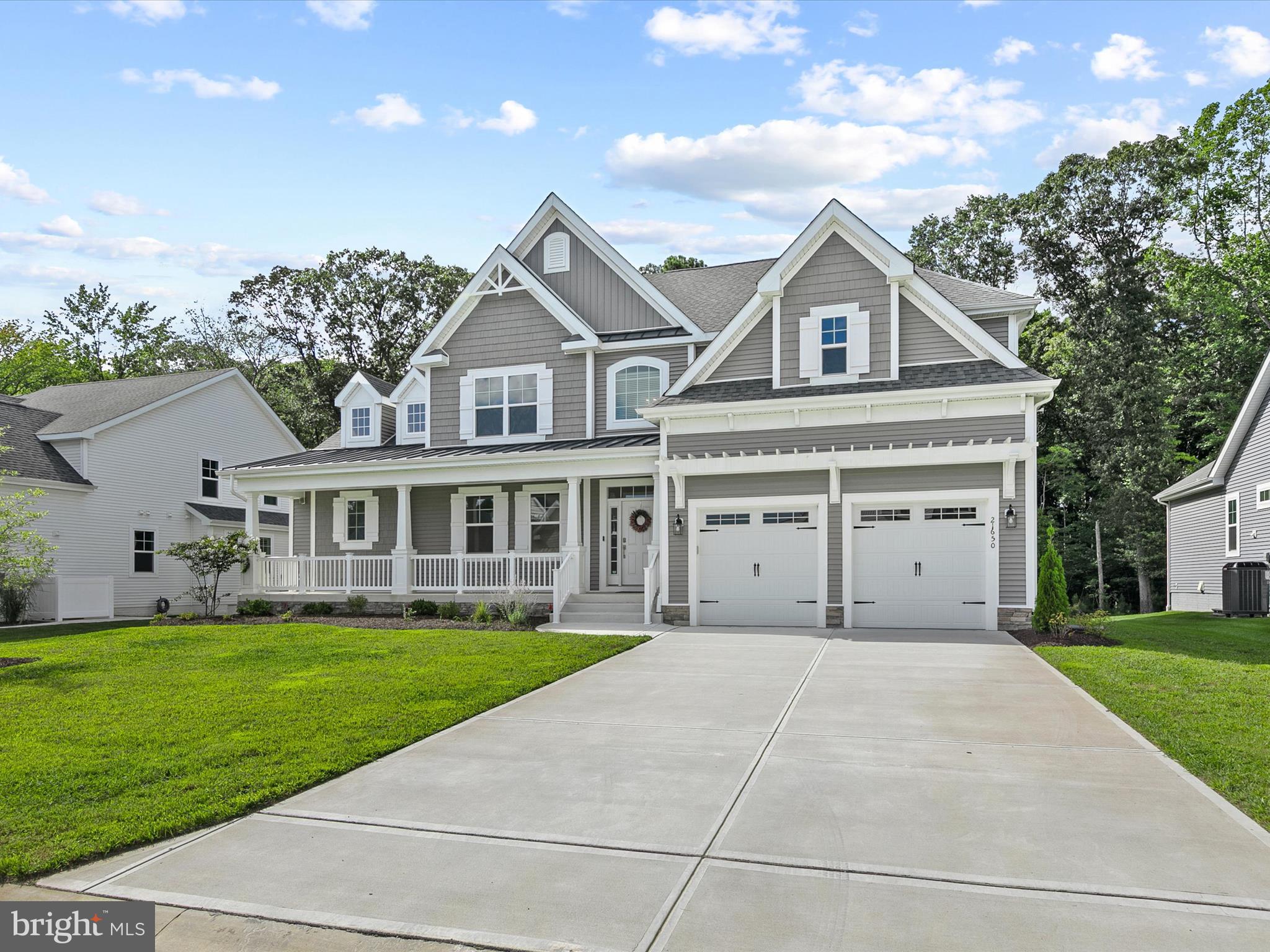 21650 Eastbridge Loop Lewes, DE 19958 - Photo 3 of 106 a front view of a house with a garden and yard