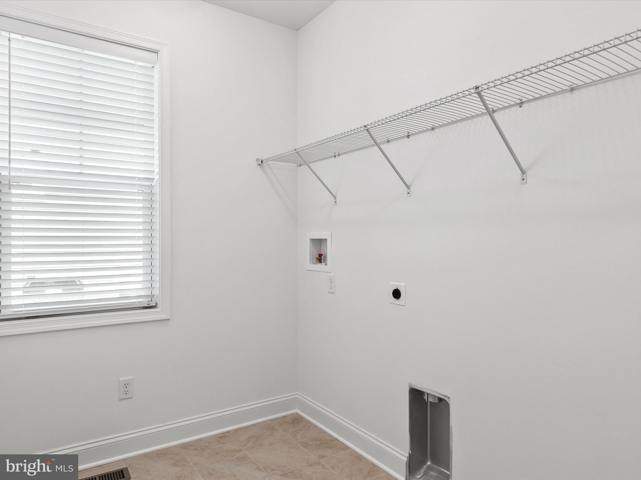 21650 Eastbridge Loop Lewes, DE 19958 - Photo 31 of 106 a view of a room with racks on the wall and a window