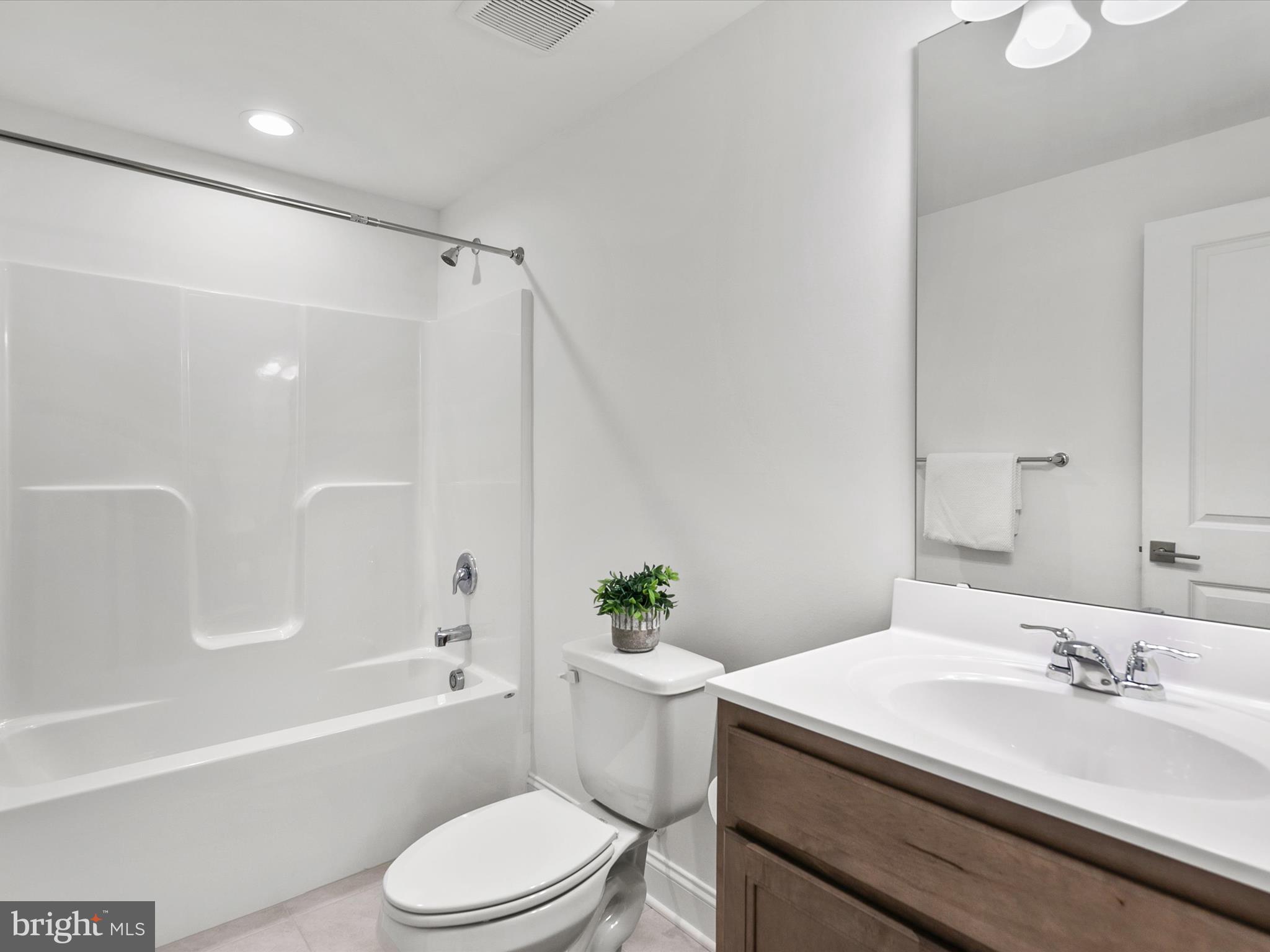 21650 Eastbridge Loop Lewes, DE 19958 - Photo 45 of 106 a bathroom with a sink a toilet and a bathtub