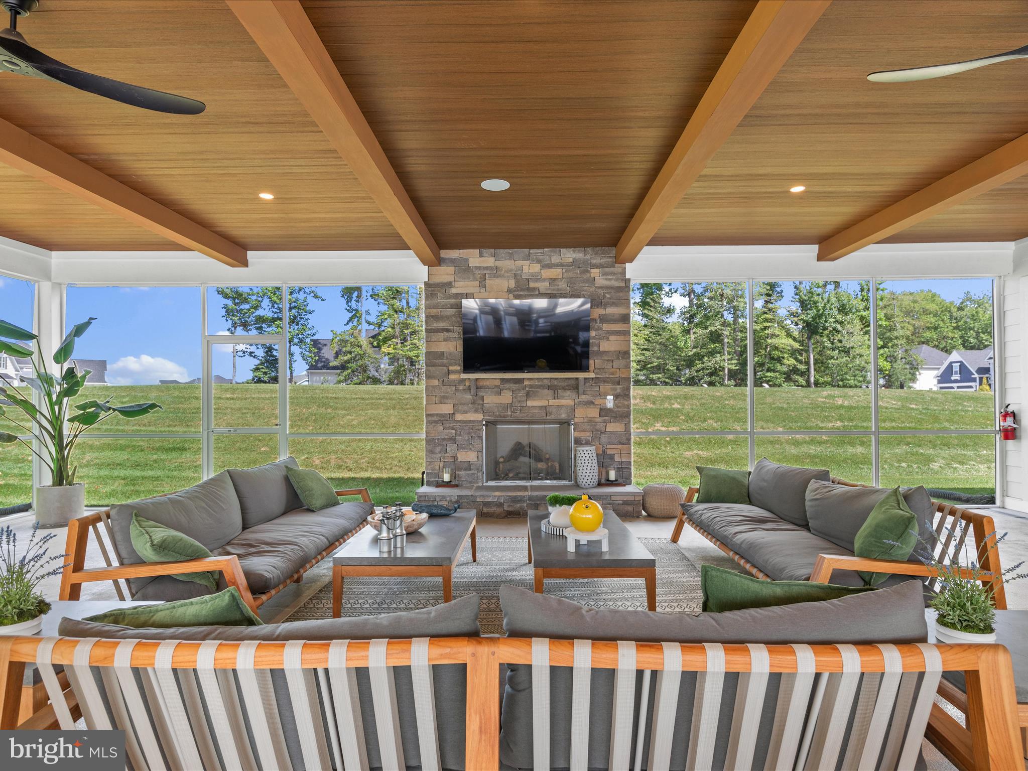 21650 Eastbridge Loop Lewes, DE 19958 - Photo 62 of 106 a view of a patio with a dining table chairs and a backyard