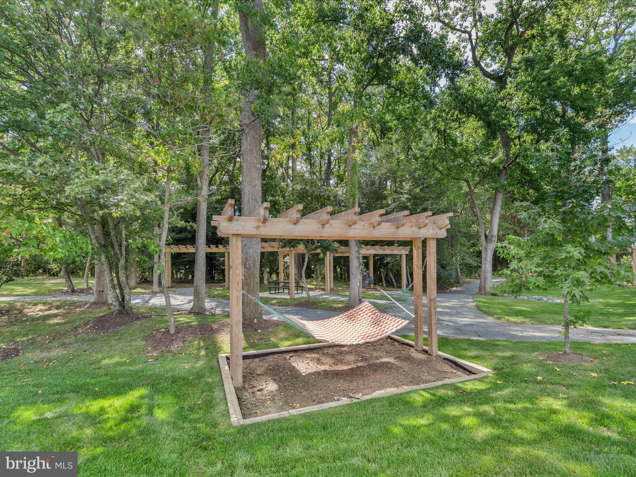 21650 Eastbridge Loop Lewes, DE 19958 - Photo 83 of 106 a view of a house with backyard porch and sitting area