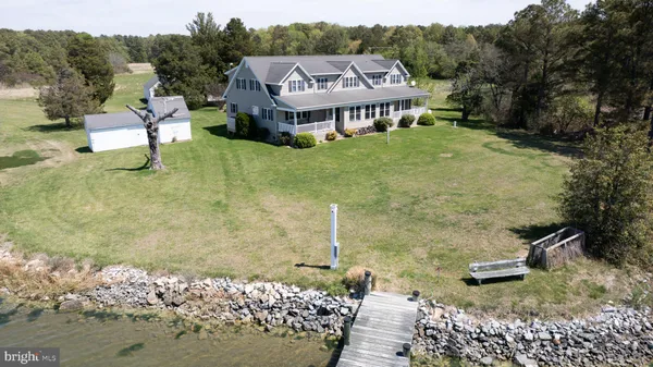 a view of a white house with a yard