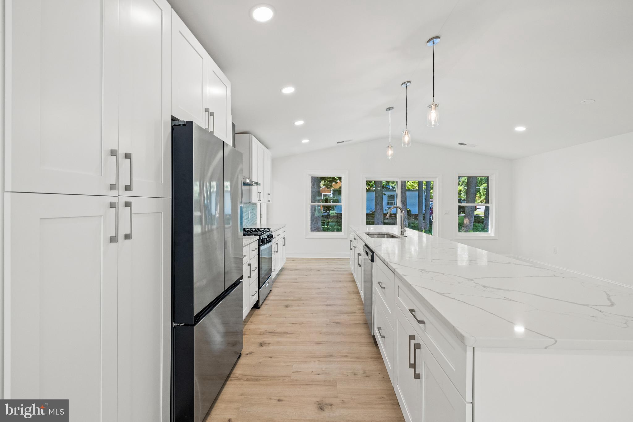 7129 Catlett Street Springfield, VA 22151 - Photo 14 of 34 a large white kitchen with a large window