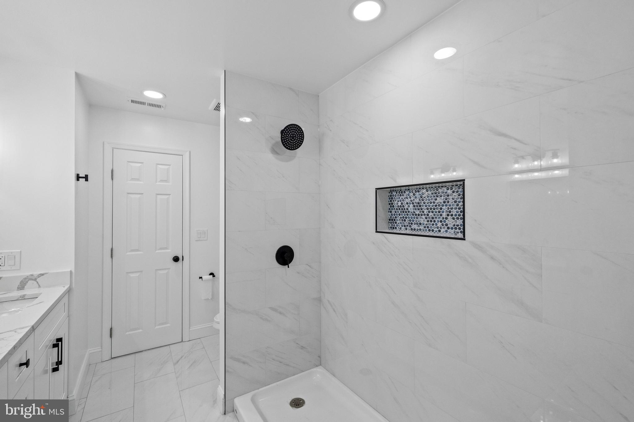 7129 Catlett Street Springfield, VA 22151 - Photo 28 of 34 a bathroom with a shower and a sink