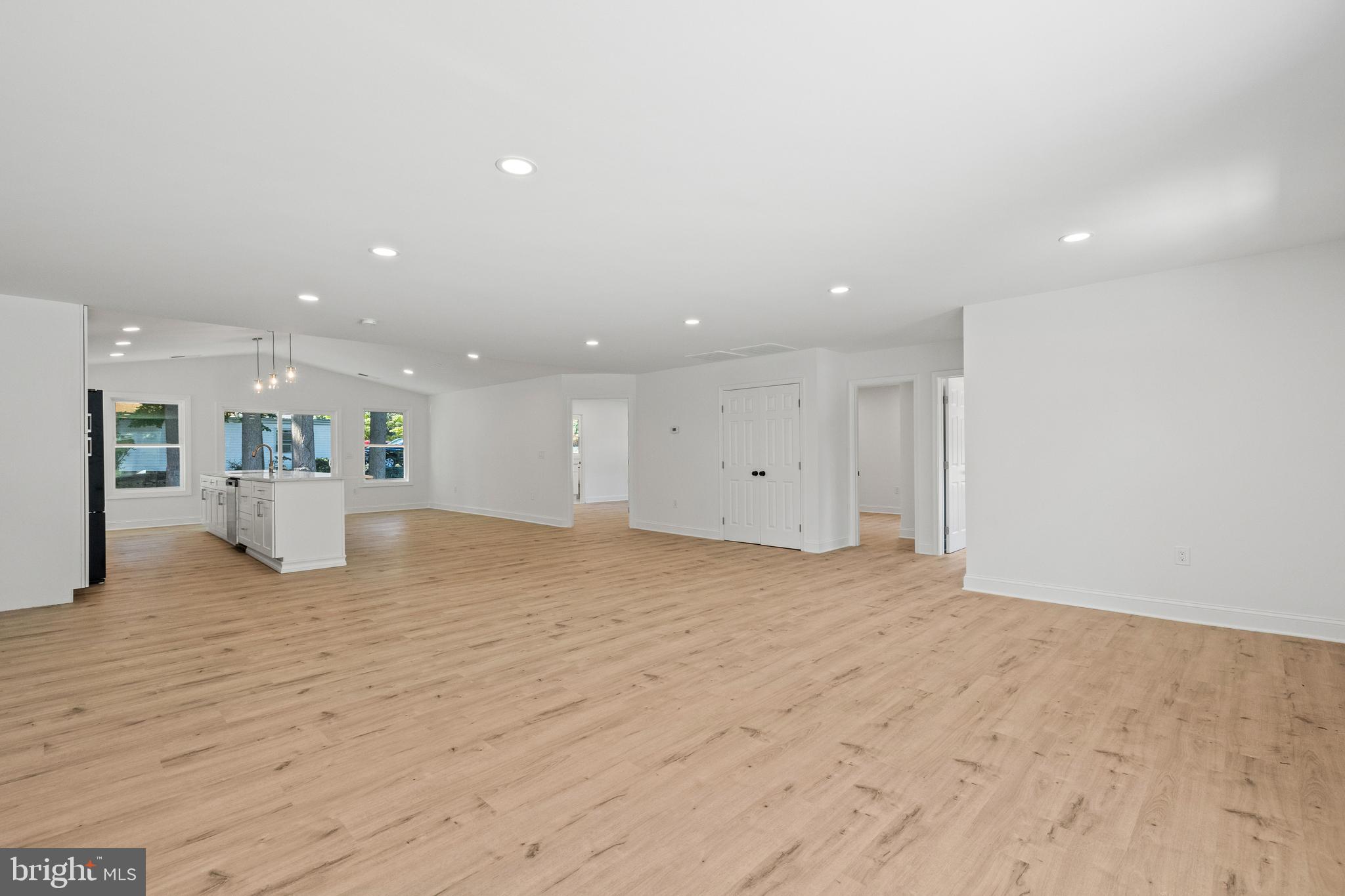 7129 Catlett Street Springfield, VA 22151 - Photo 6 of 34 a view of an empty room with wooden floor and kitchen