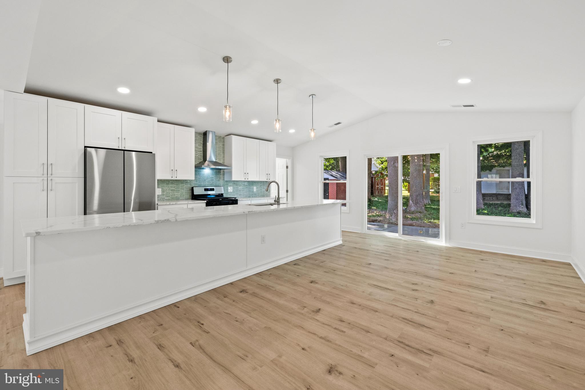 7129 Catlett Street Springfield, VA 22151 - Photo 8 of 34 a view of kitchen with refrigerator stove and wooden floor