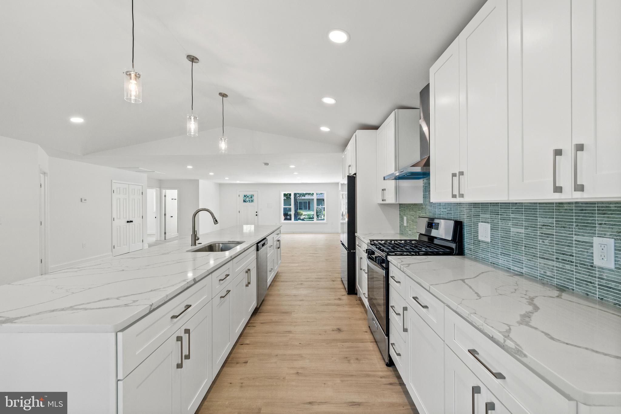 7129 Catlett Street Springfield, VA 22151 - Photo 10 of 34 a large kitchen with stainless steel appliances granite countertop a lot of counter space
