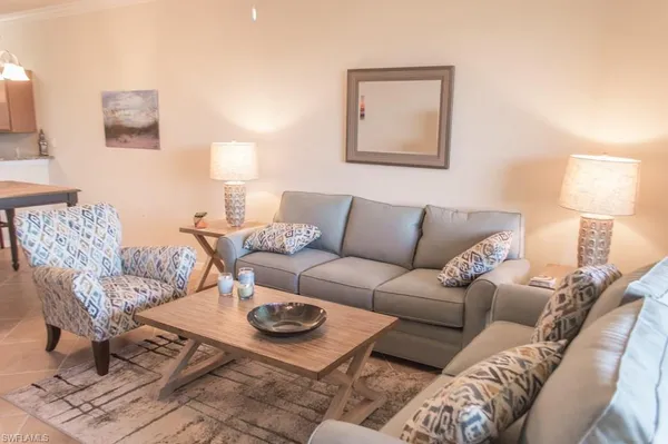 a living room with furniture and a lamp