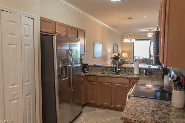 a kitchen with stainless steel appliances granite countertop a sink stove and microwave