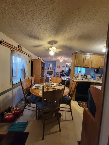 a view of a dining room with furniture and chandelier