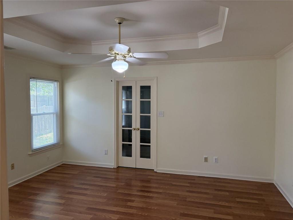 3089 Commons Crossing Snellville, GA 30078 - Photo 7 of 16 a view of an empty room with wooden floor and a window