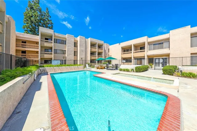 a swimming pool with buildings in the background