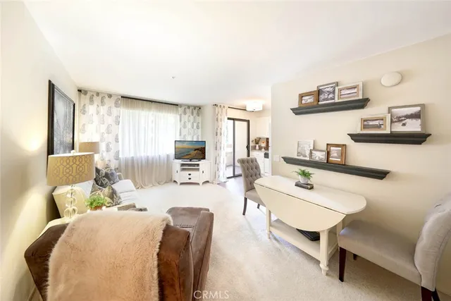 a bedroom with a bed a couch and large windows