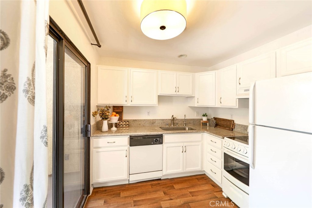 351 North Ford Avenue, Unit 213 Fullerton, CA 92832 - Photo 8 of 13 a kitchen with a sink a refrigerator and cabinets