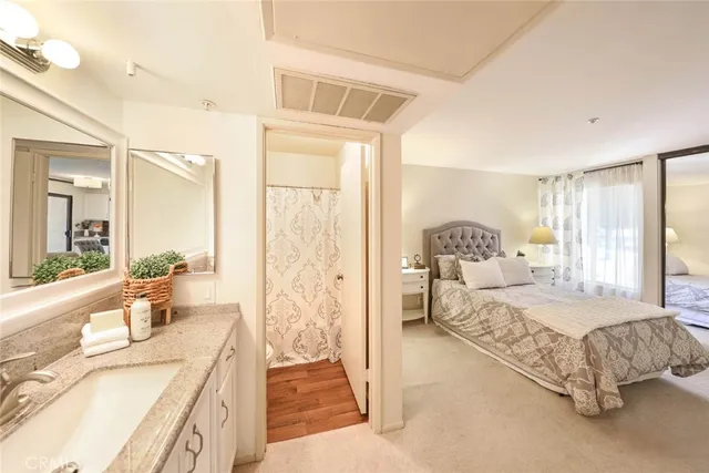 a spacious bedroom with a bed and a large window