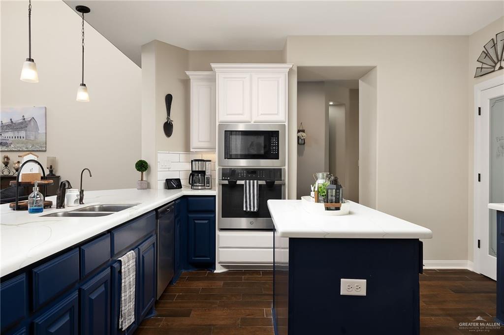 6323 Cascada Bnd Road McAllen, TX 78504 - Photo 12 of 26 a kitchen with a sink and a microwave