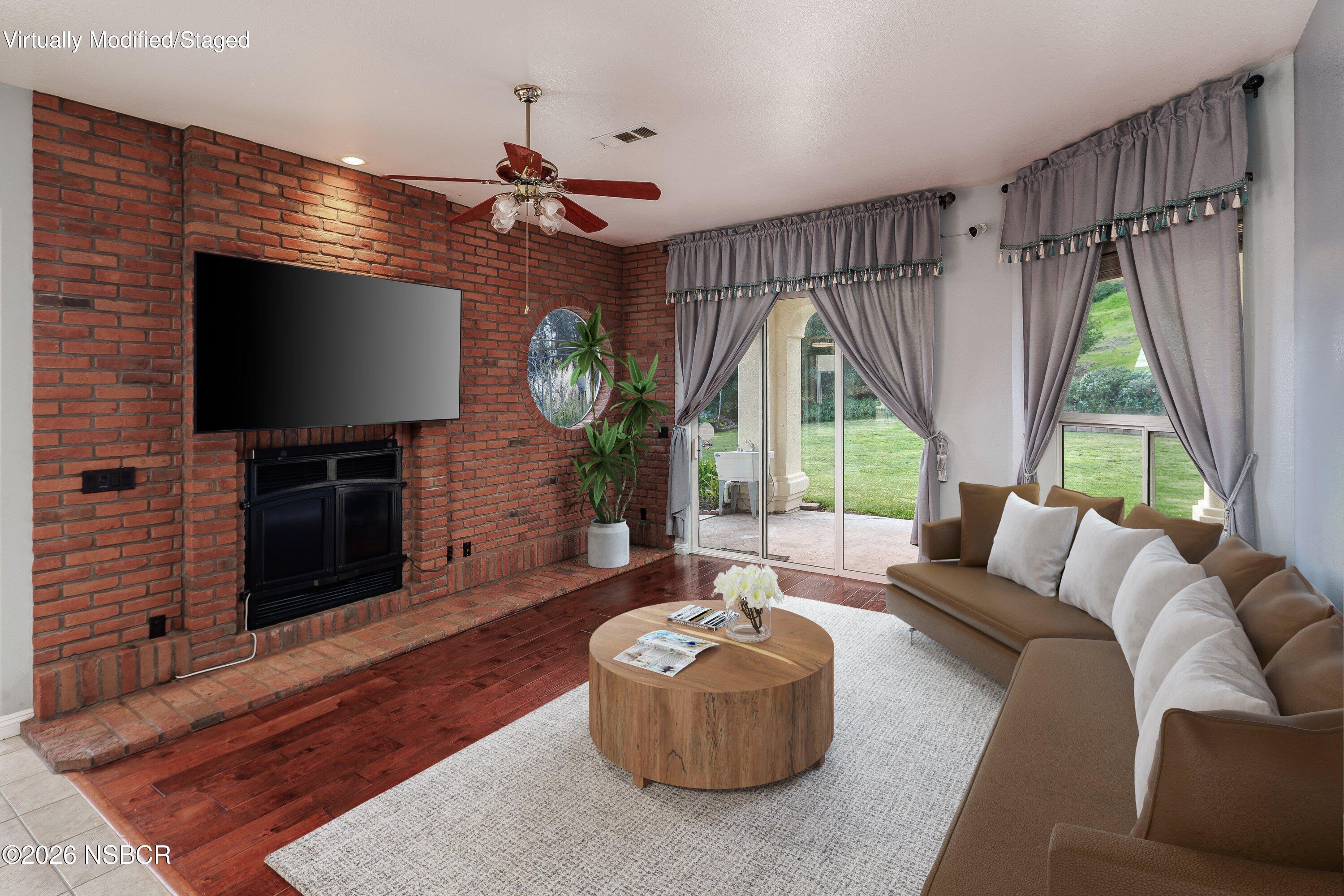 2655 Adobe Falls Road Lompoc, CA 93436 - Photo 17 of 51 a living room with fireplace furniture and a flat screen tv