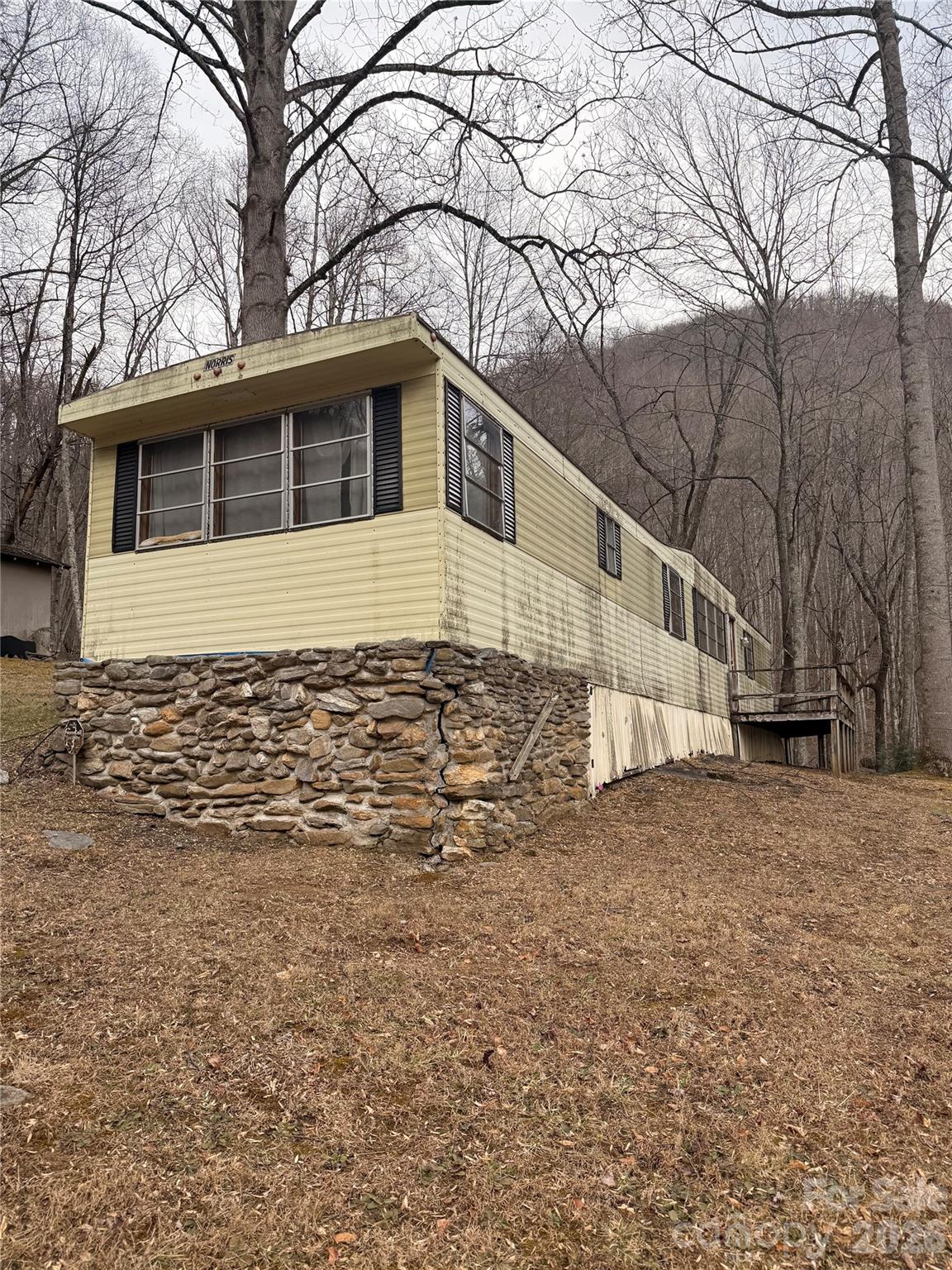 2094 Fisher Crk Road Sylva, NC 28779 - Photo 2 of 8 a house that has a tree in front of it