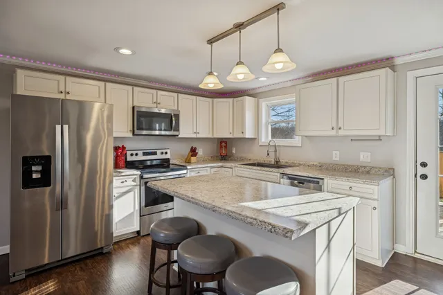 a kitchen with a stove a refrigerator and a sink