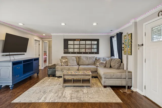 a living room with furniture and a flat screen tv