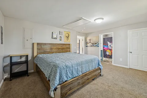 a spacious bedroom with a bed and a cabinets