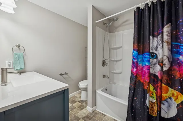 a bathroom with a sink toilet and shower
