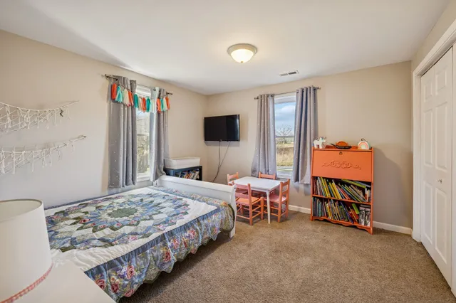 a bedroom with bed and a window