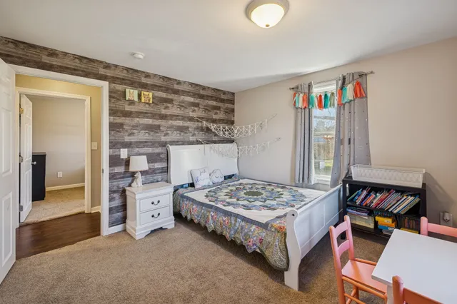 a bedroom with a bed and a dresser