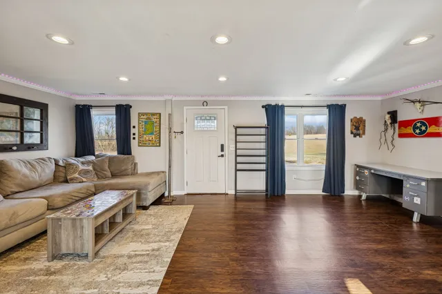 a living room with furniture and a wooden floor