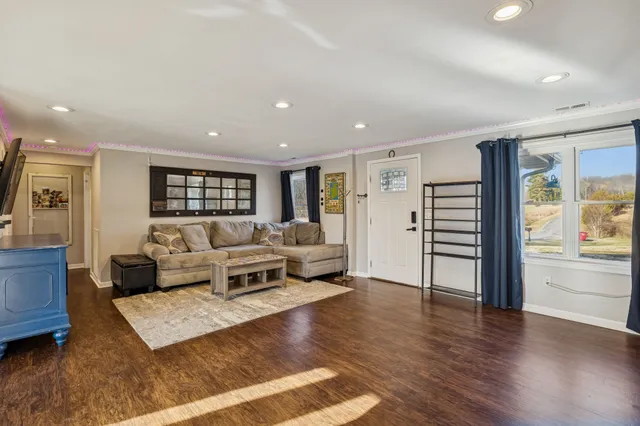 a living room with furniture and wooden floor