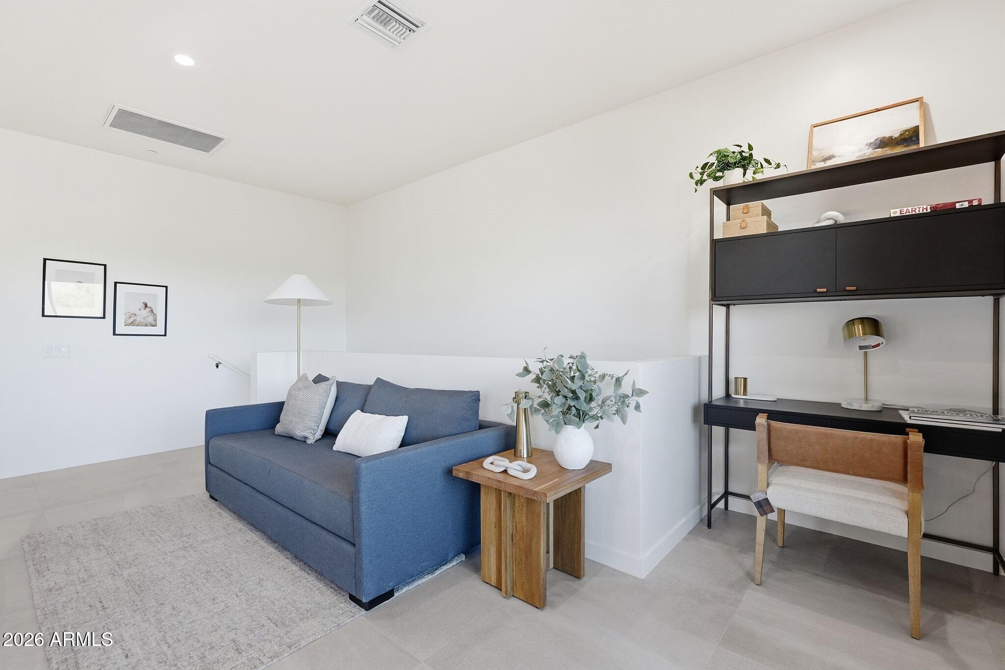 6525 East Cave Creek Road, Unit 201 Cave Creek, AZ 85331 - Photo 15 of 33 a living room with furniture and a potted plant