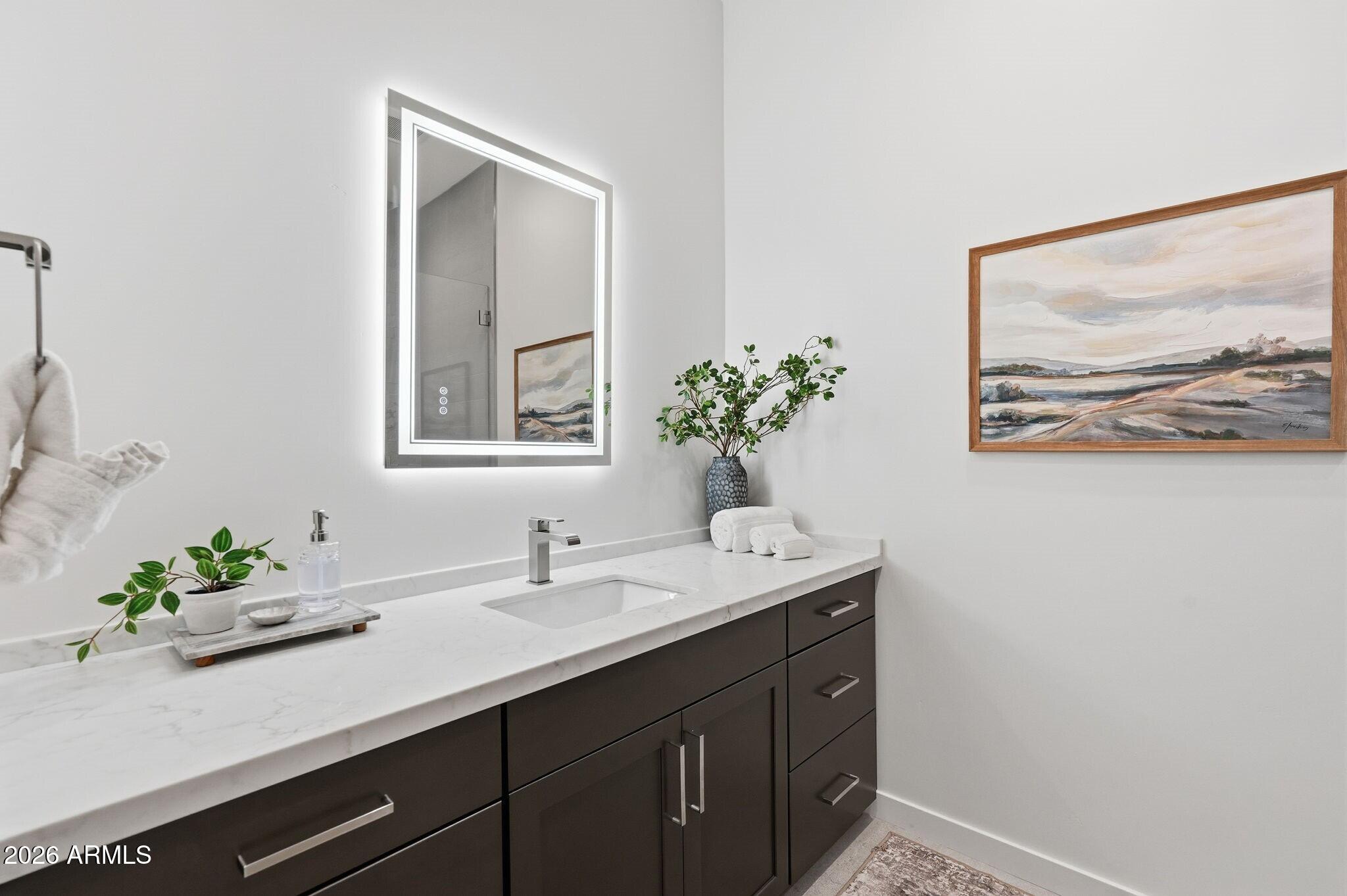 6525 East Cave Creek Road, Unit 201 Cave Creek, AZ 85331 - Photo 23 of 33 a bathroom with a sink mirror and vanity