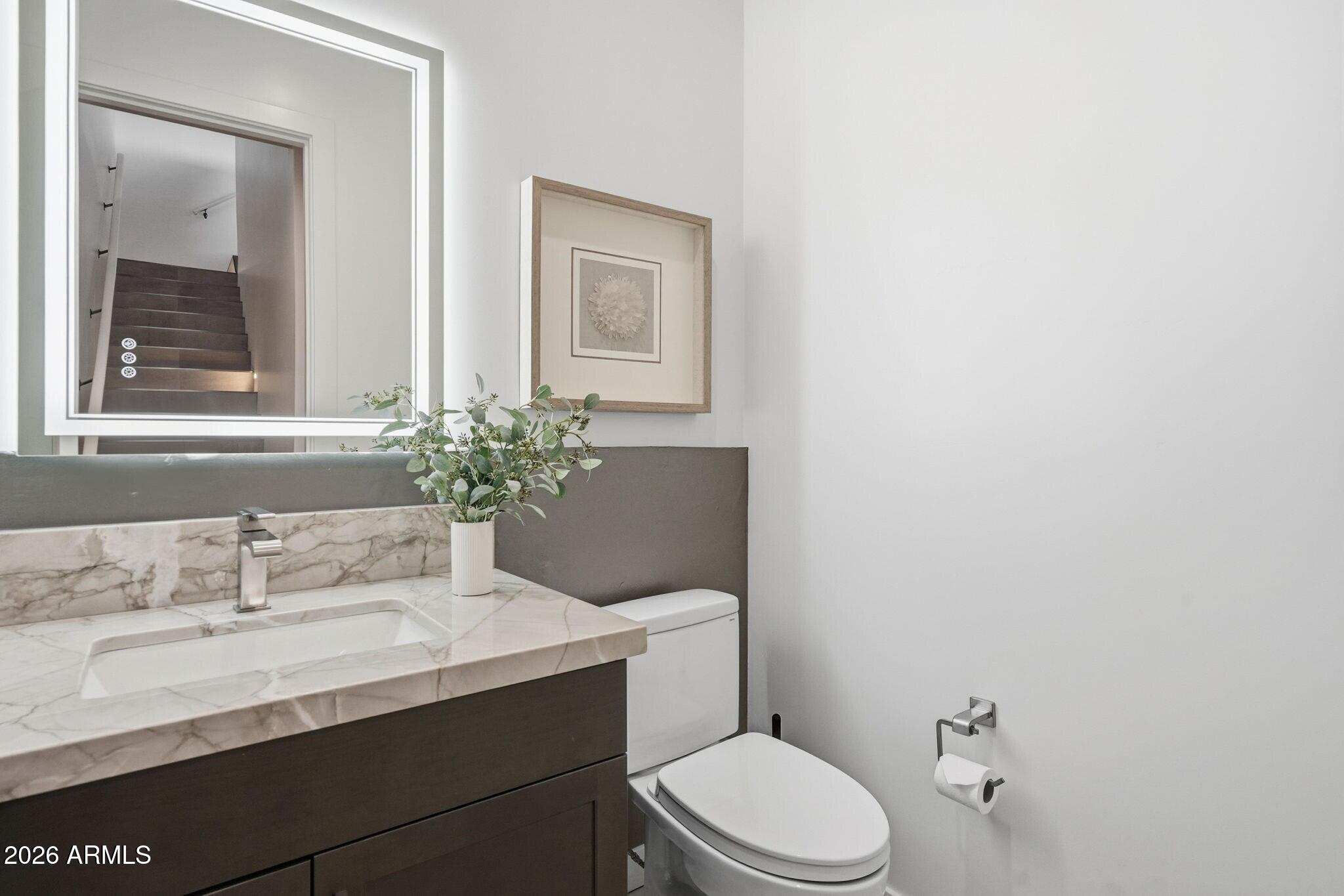 6525 East Cave Creek Road, Unit 201 Cave Creek, AZ 85331 - Photo 25 of 33 a bathroom with a toilet a sink and mirror
