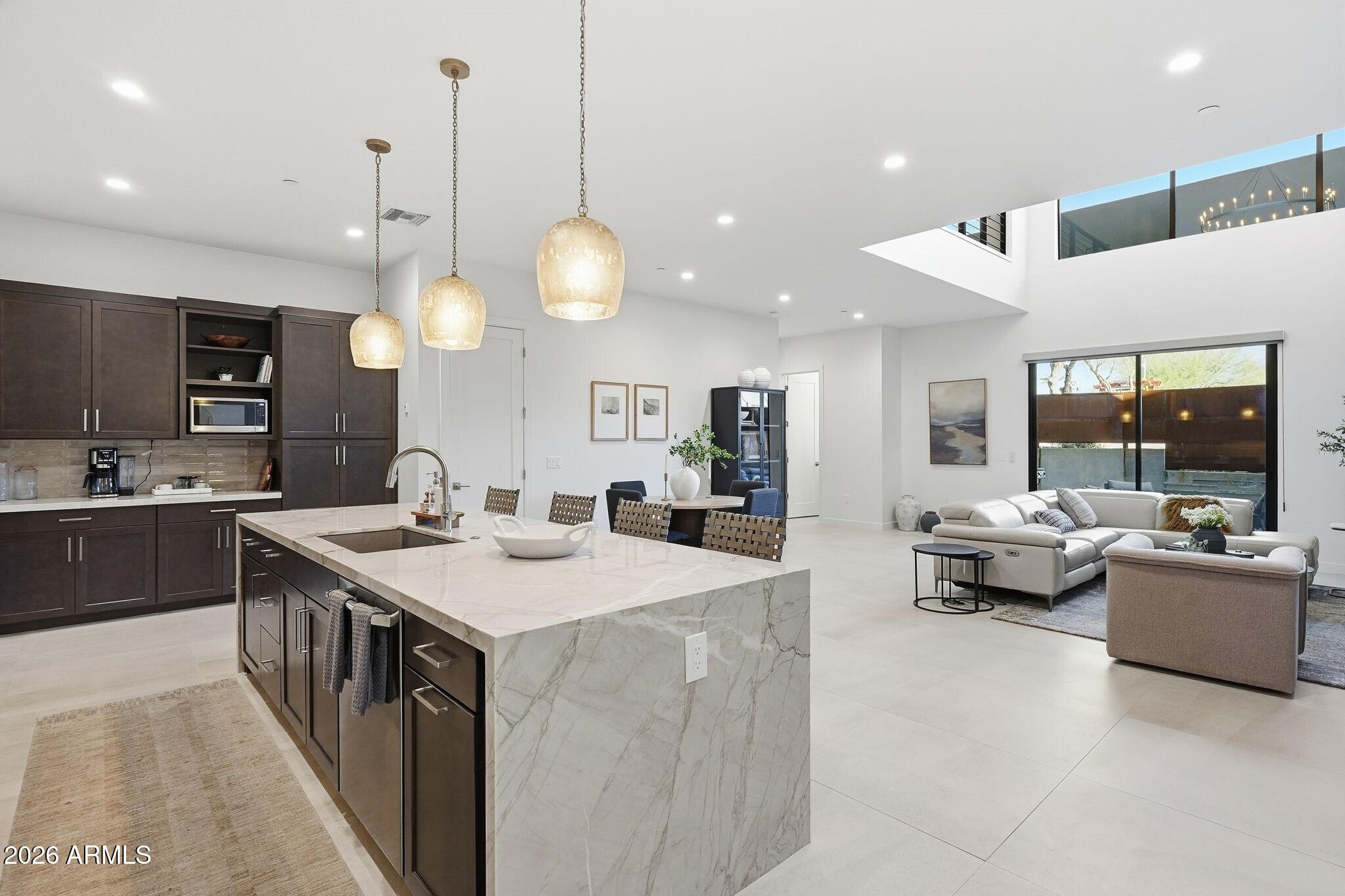 6525 East Cave Creek Road, Unit 201 Cave Creek, AZ 85331 - Photo 9 of 33 a large kitchen with kitchen island a sink a counter space and stainless steel appliances