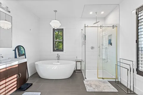 a spacious bathroom with a bathtub and shower