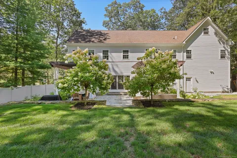 a front view of a house with a garden