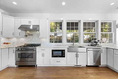 a kitchen with stainless steel appliances granite countertop a stove and a sink