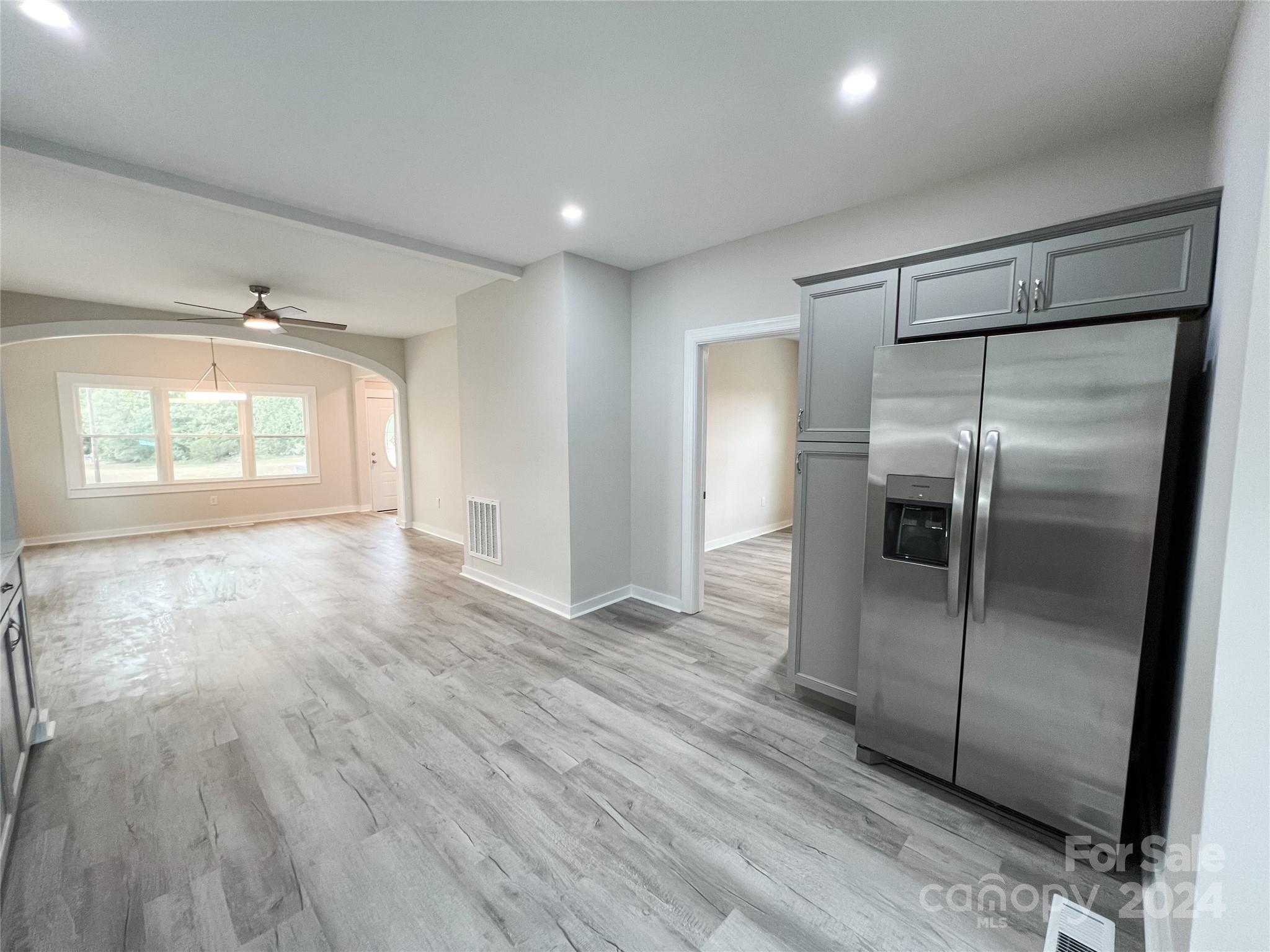 816 Laton Road Albemarle, NC 28001 - Photo 11 of 28 an empty room with wooden floor and windows