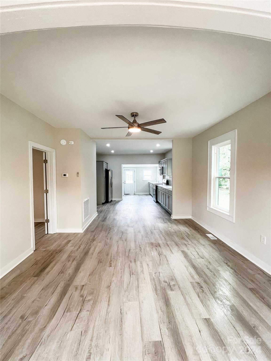 816 Laton Road Albemarle, NC 28001 - Photo 13 of 28 a view of empty room with wooden floor and windows