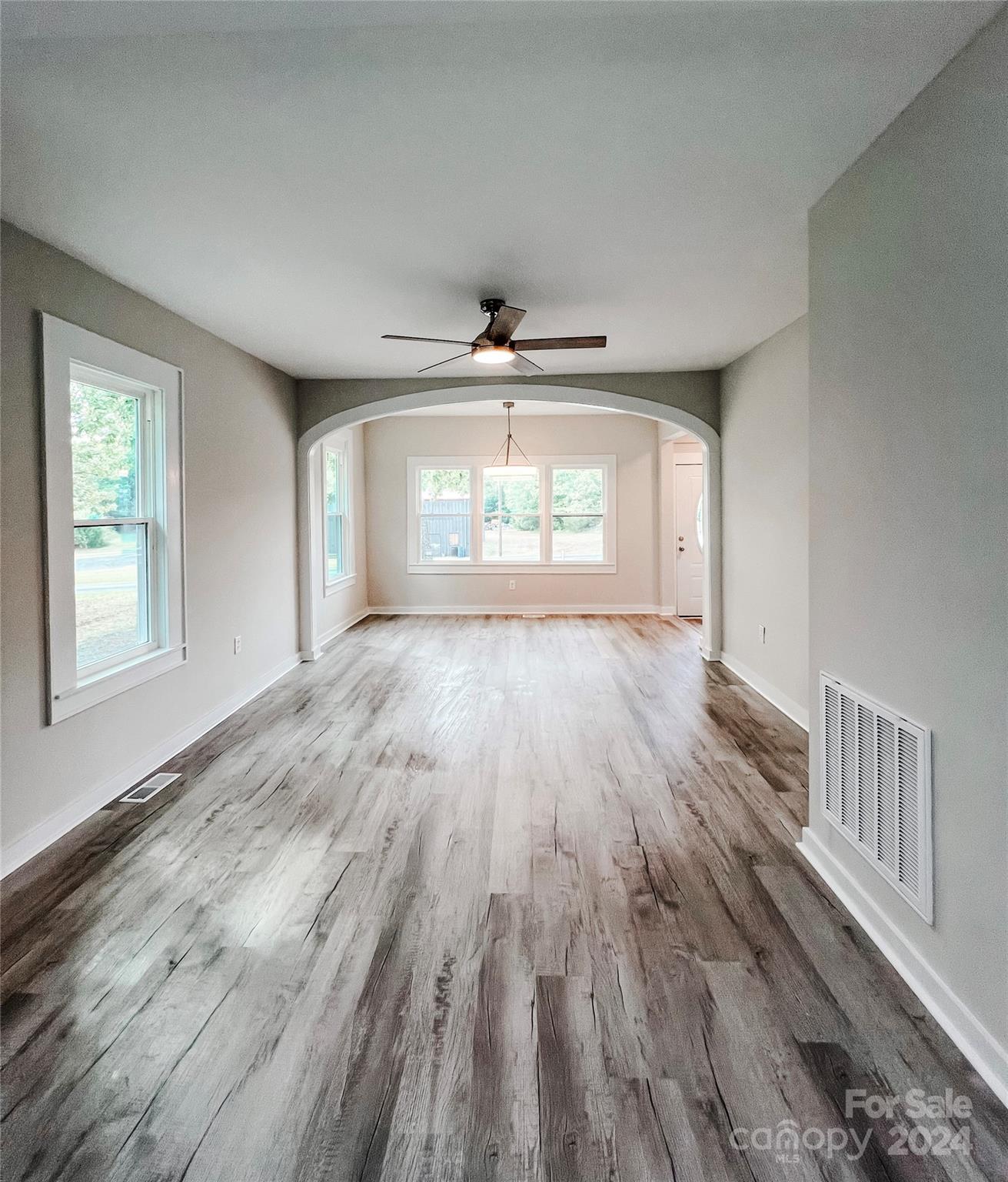 816 Laton Road Albemarle, NC 28001 - Photo 14 of 28 an empty room with wooden floor and windows