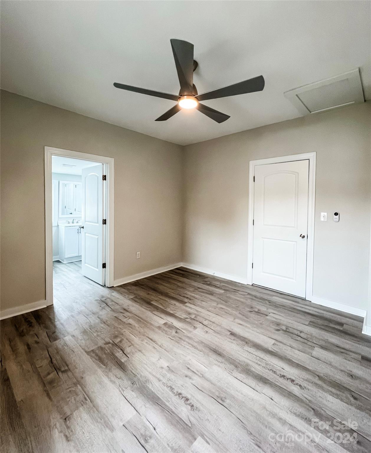 816 Laton Road Albemarle, NC 28001 - Photo 18 of 28 an empty room with wooden floor closet and ceiling fan