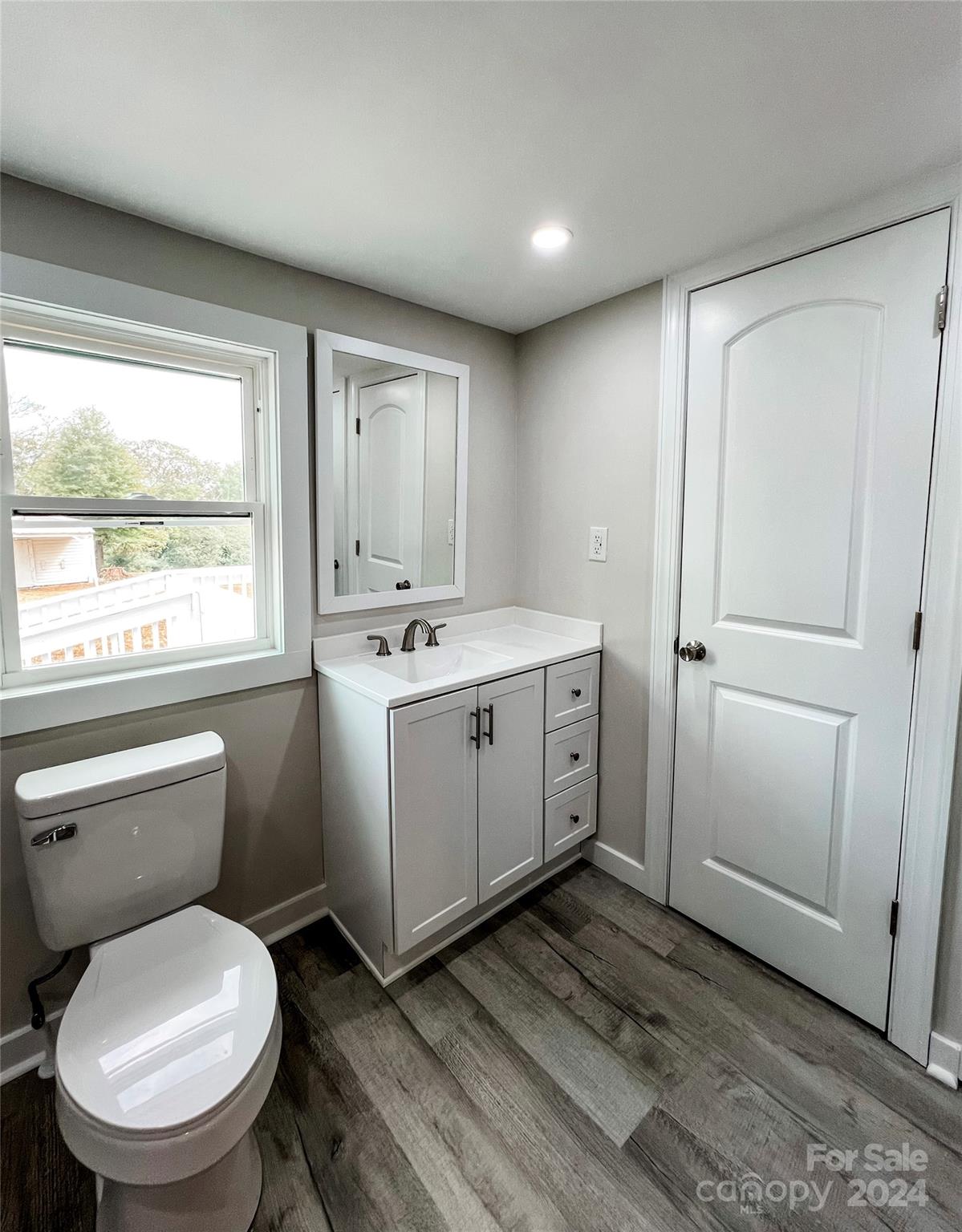 816 Laton Road Albemarle, NC 28001 - Photo 19 of 28 a bathroom with a toilet sink and mirror