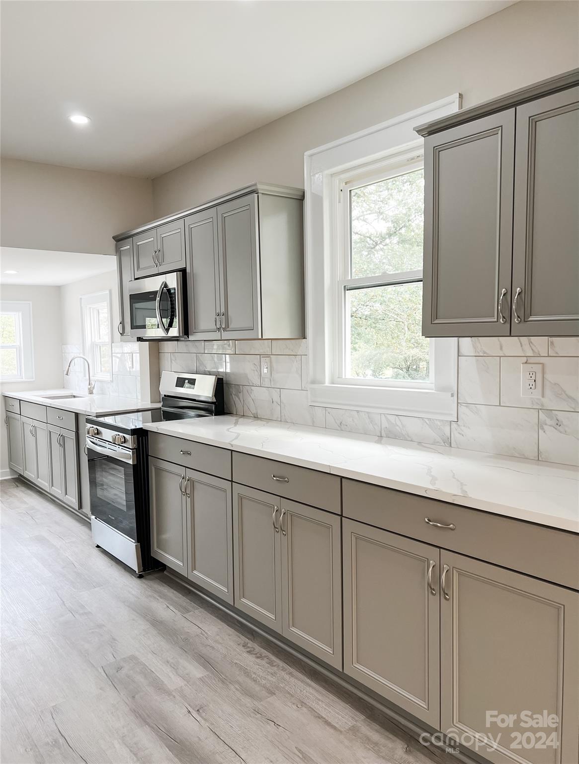 816 Laton Road Albemarle, NC 28001 - Photo 8 of 28 a kitchen with kitchen island granite countertop a sink cabinets and window