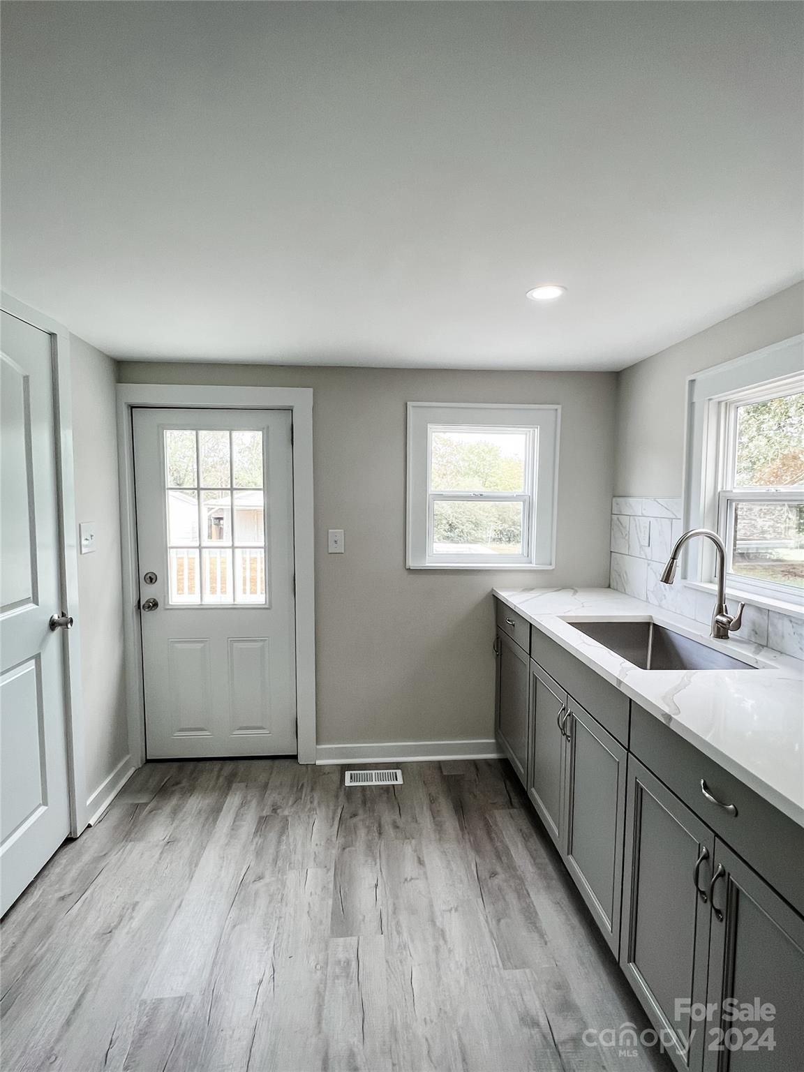 816 Laton Road Albemarle, NC 28001 - Photo 9 of 28 a view of a kitchen with wooden floor and window