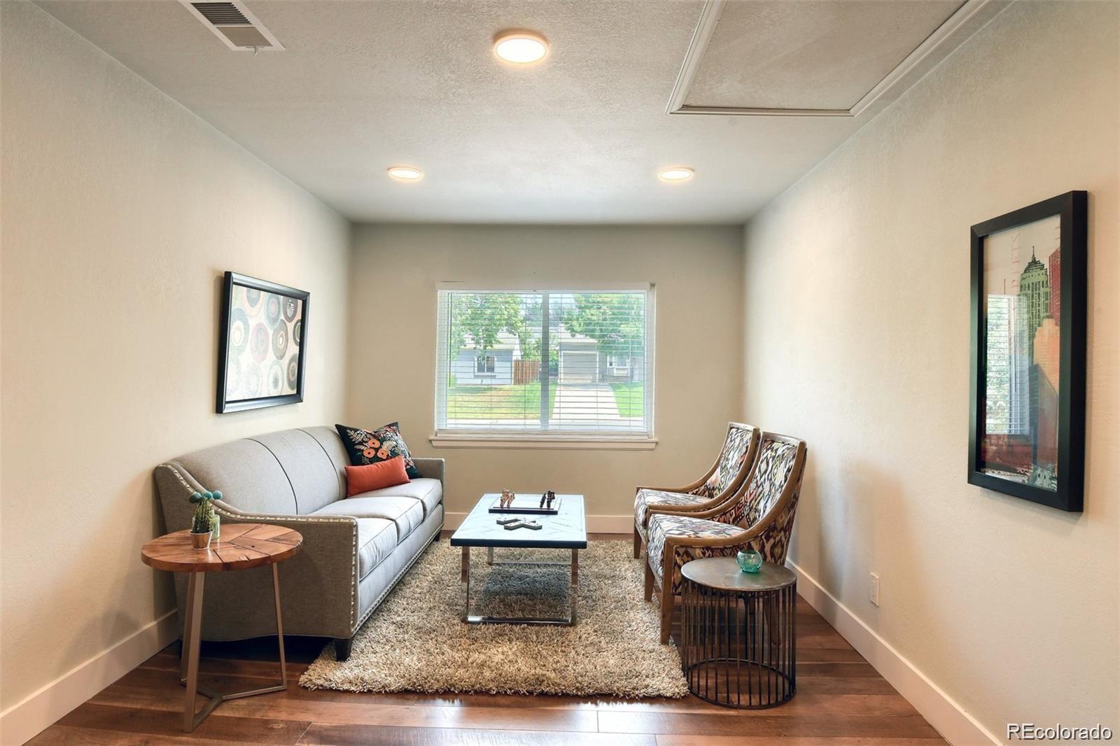 3075 South Grape Way Denver, CO 80222 - Photo 18 of 25 a living room with furniture and a window