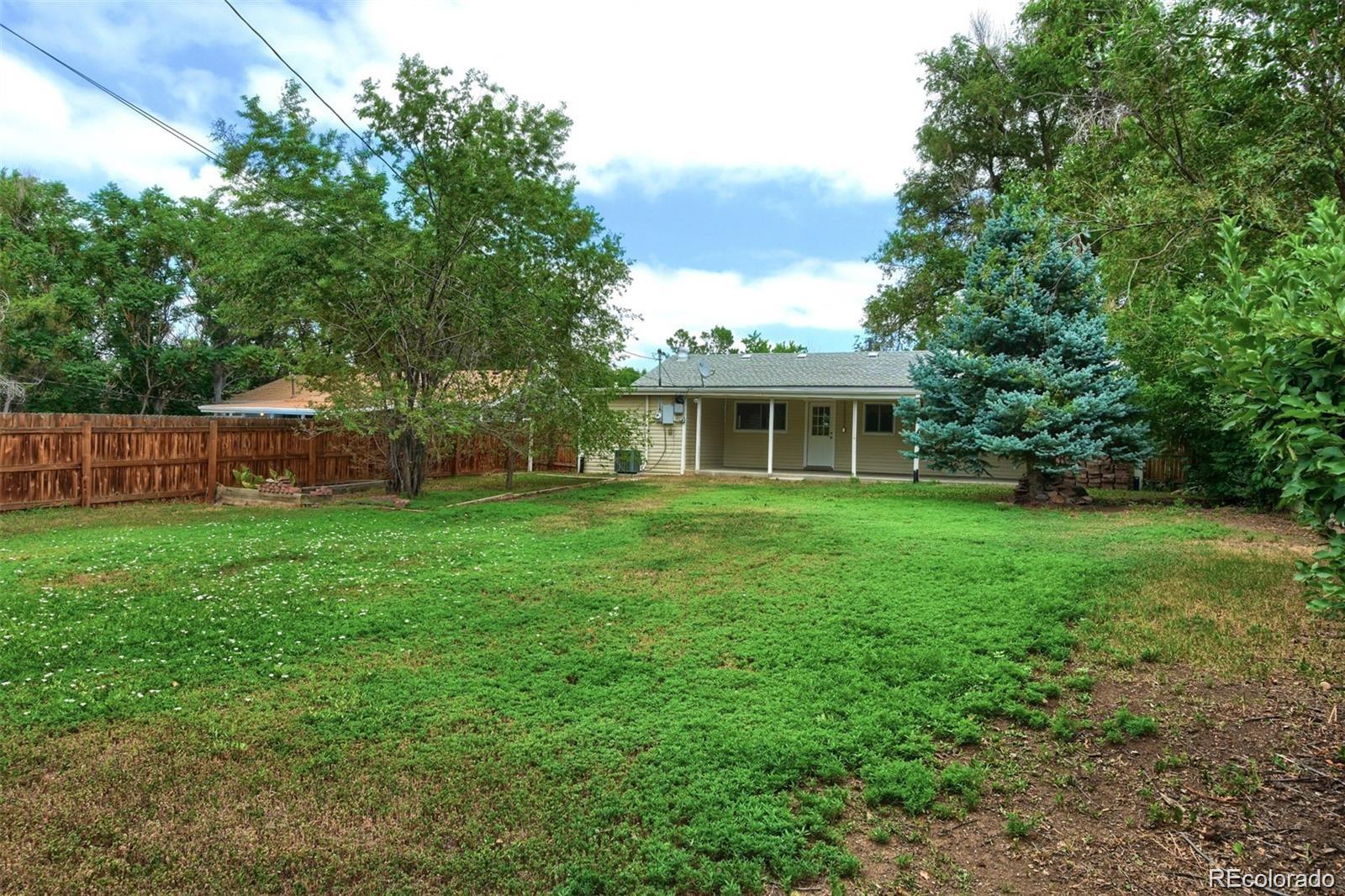 3075 South Grape Way Denver, CO 80222 - Photo 23 of 25 a view of a house with backyard and a tree