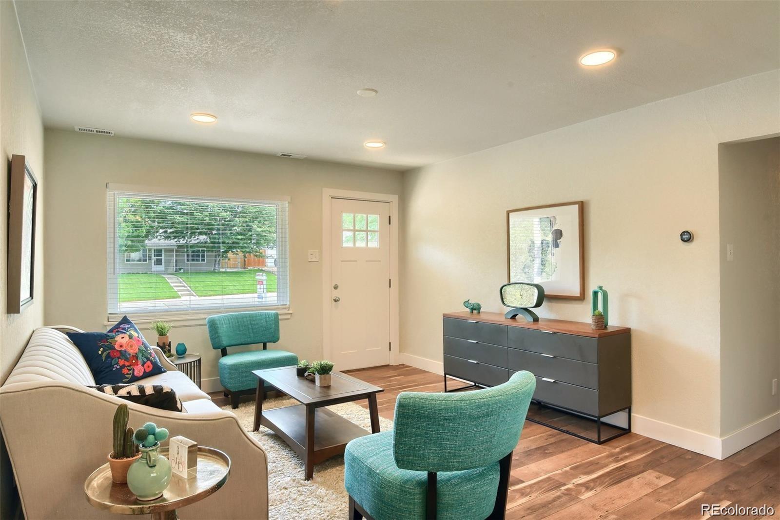 3075 South Grape Way Denver, CO 80222 - Photo 3 of 25 a living room with furniture and a window
