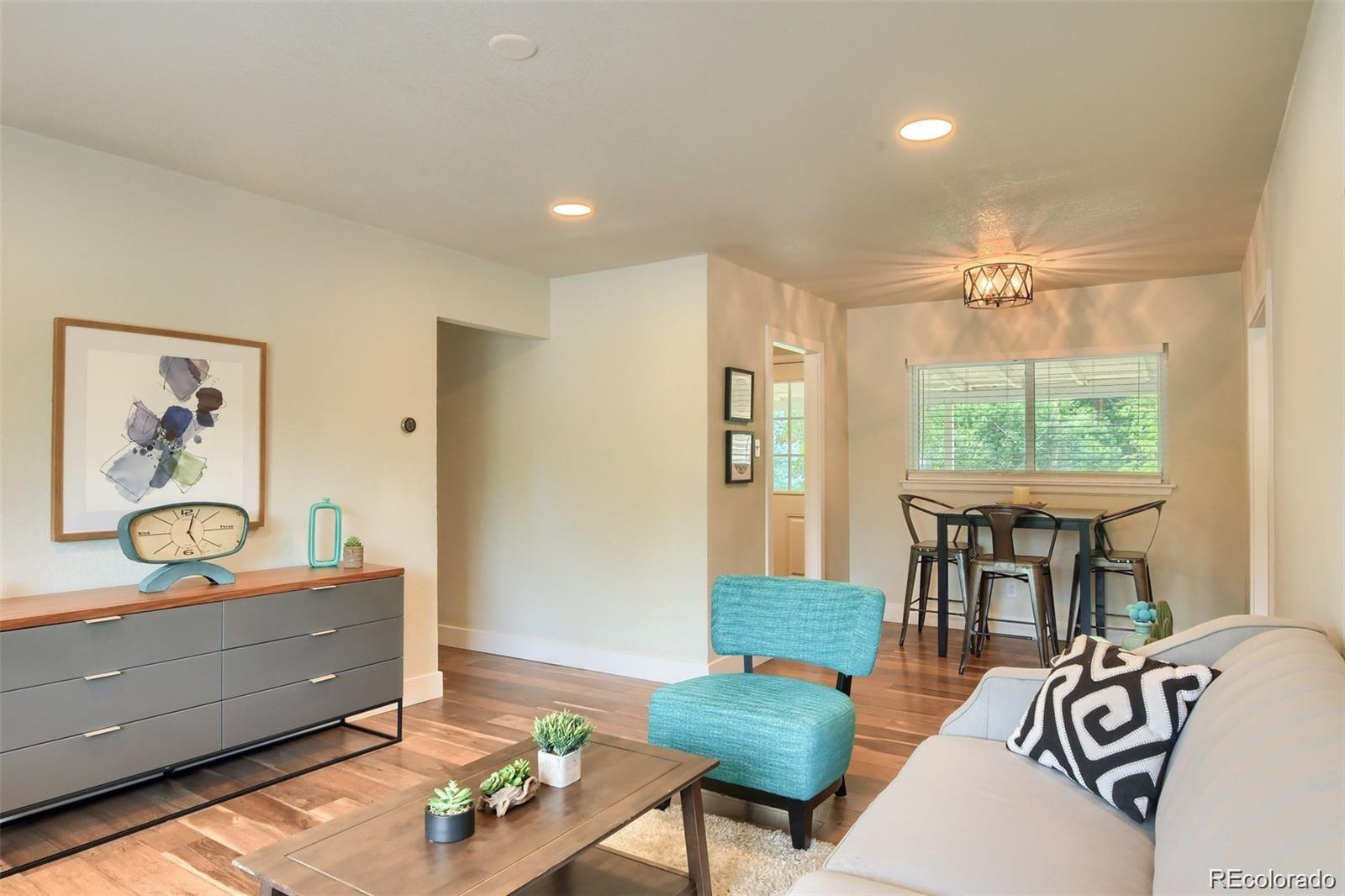 3075 South Grape Way Denver, CO 80222 - Photo 4 of 25 a living room with furniture and a table
