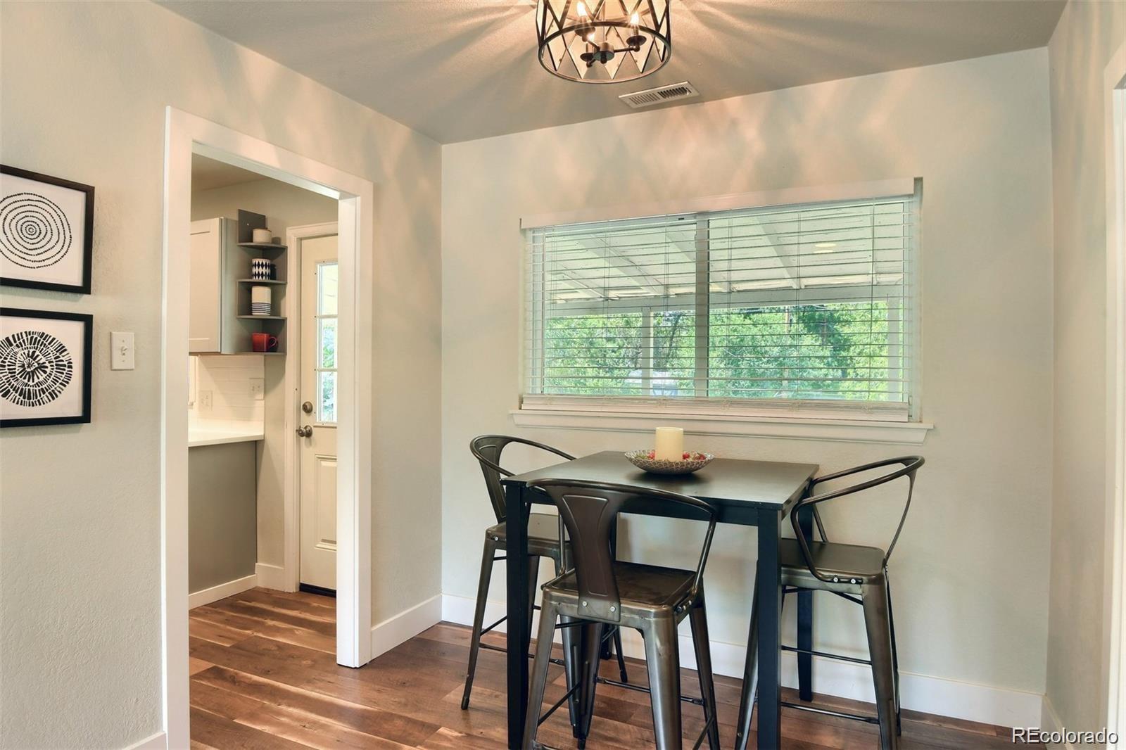 3075 South Grape Way Denver, CO 80222 - Photo 9 of 25 a dining room with furniture and window